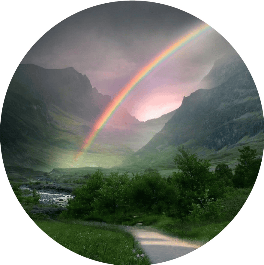 Vivid rainbow arching over lush green valley with mountains in the background.