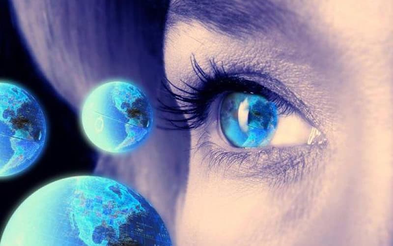 Close-up of a woman's eye with viewing the Earth.